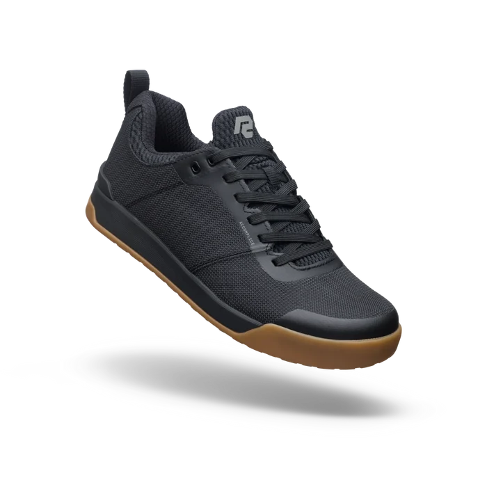 Black sneaker with brown sole on a white background