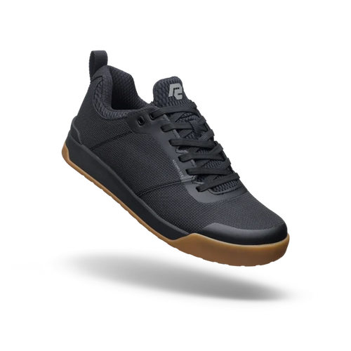 Black sneaker with brown sole on a white background