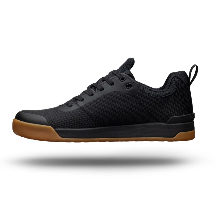 Black sneaker with brown sole on a white background