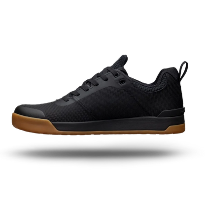 Black sneaker with brown sole on a white background