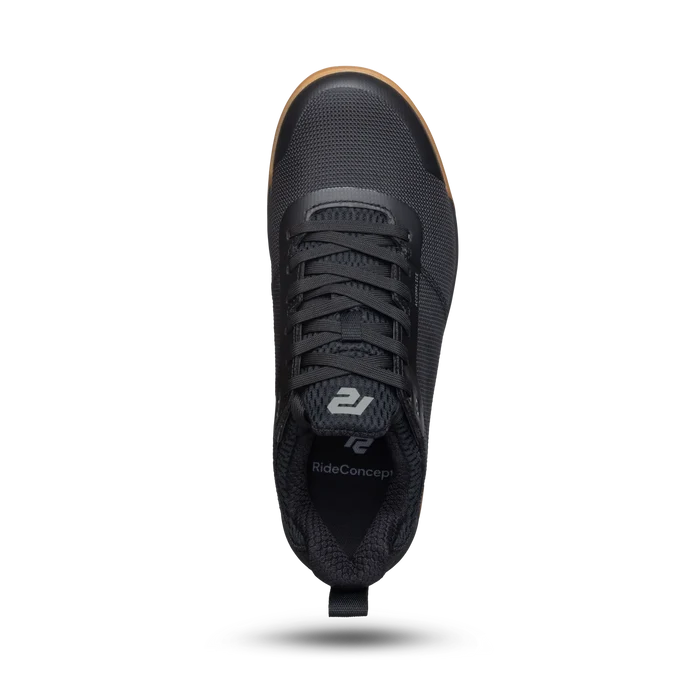 Black sneaker with visible brand logo on a white background