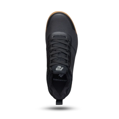 Black sneaker with visible brand logo on a white background
