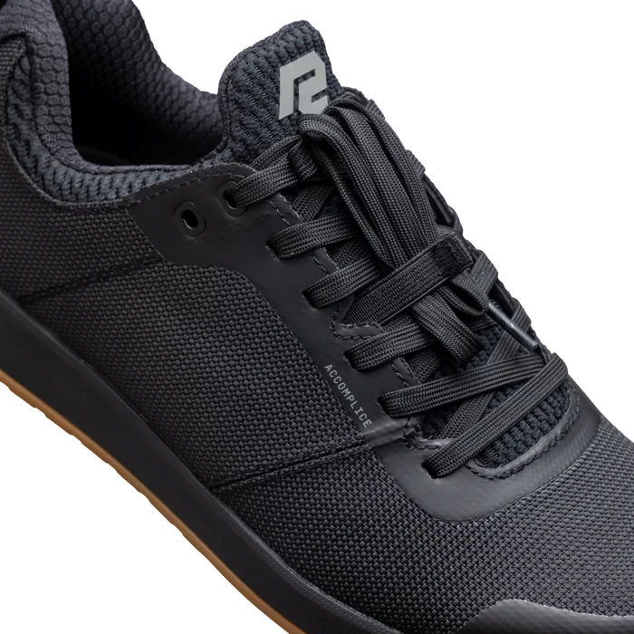 Black athletic shoe with brand logo on a white background