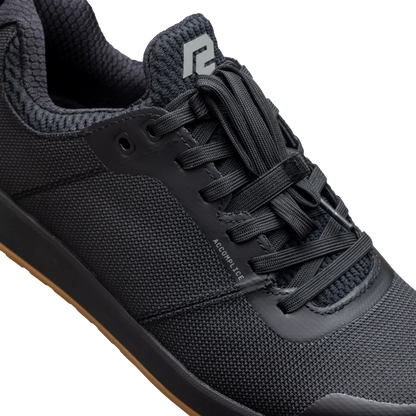 Black athletic shoe with brand logo on a white background