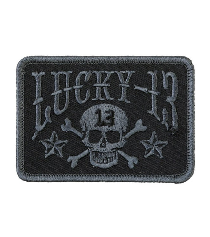 Fully embroidered black on black patch with skull and crossbones, stars, and Lucky 13 logo.