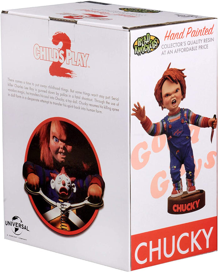 box of Head knocker bobble head of Chucky from Child's Play 2. Chucky has his right hand up, mouth open as if he is yelling, and in his left hand is clutching a knife. Chucky stands on a small round platform that reads "CHUCKY" in red letters on the front.