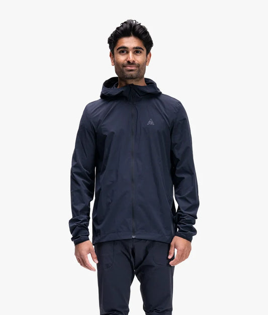 Man wearing a dark blue raincoat on a white background