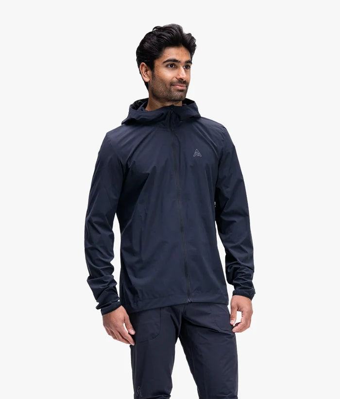 Man wearing a dark blue hooded jacket on a white background
