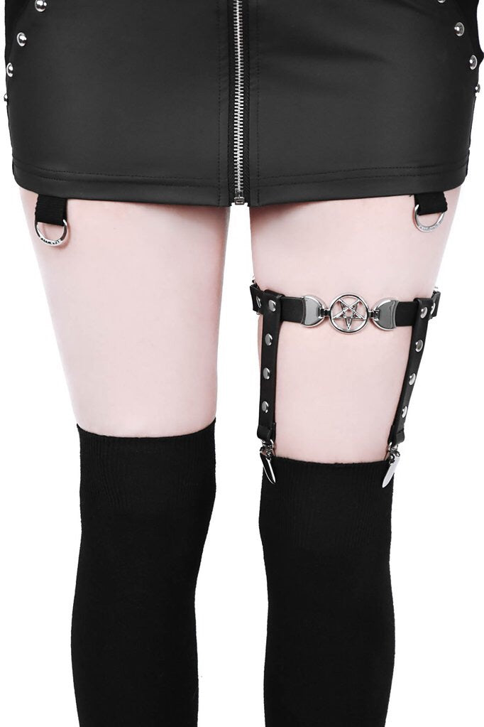 front view of black leg garter with vegan leather statement pentagram. Has adjustable elastic back, stud detail and suspender holders.