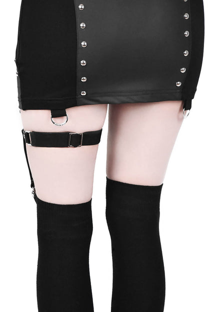 back view of black leg garter with vegan leather statement pentagram. Has adjustable elastic back, stud detail and suspender holders.