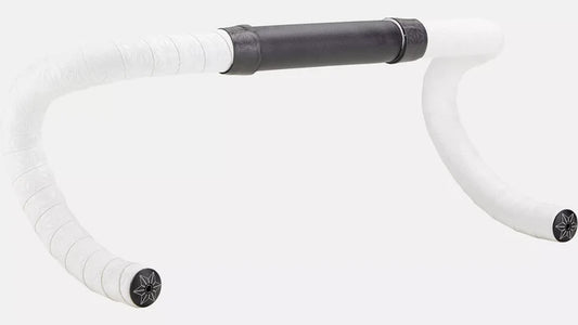 A close-up of a bicycle drop handlebar with white tape wrapped on the curved sections and a black center grip section, shown against a plain light gray background.