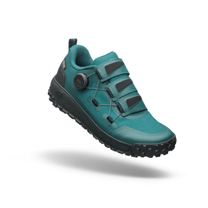 Teal hiking shoe with black sole on a white background